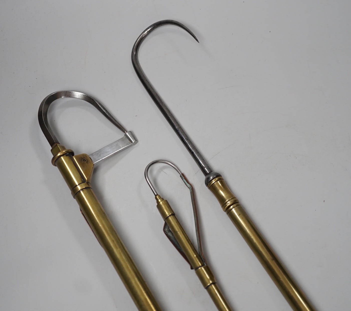 Three brass telescopic fishing gaffs